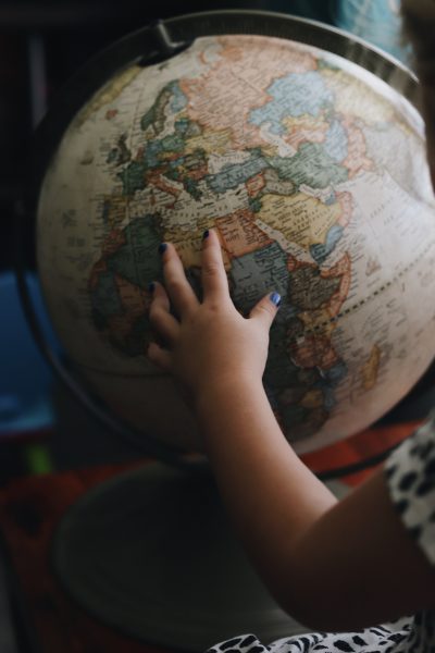 Child's hand on globe