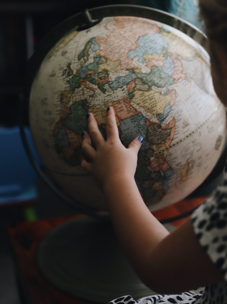 Child's hand on globe